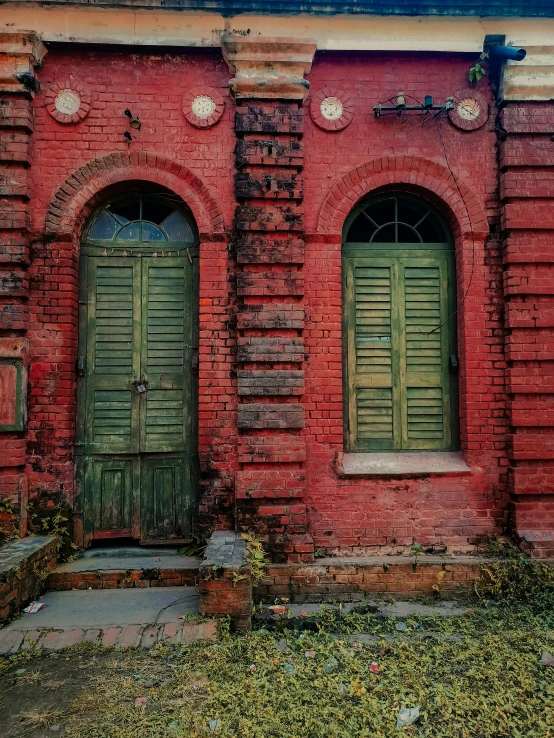 there are two doors and a window on the side of this building