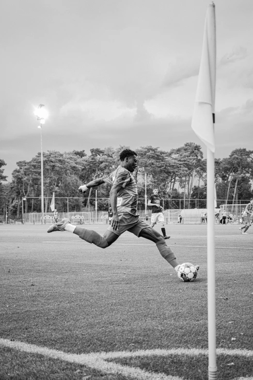 man taking pos of soccer ball on field