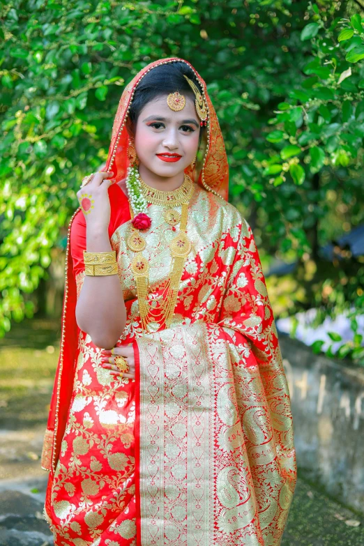 a young woman wearing an indian garb with orange and red makeup