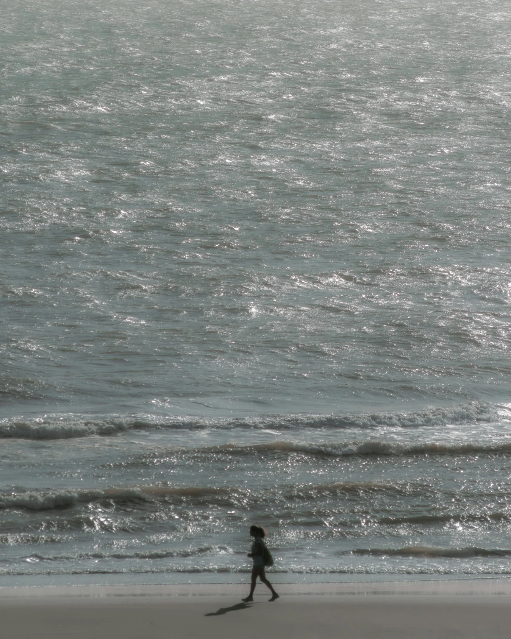 a little boy that is standing in the sand