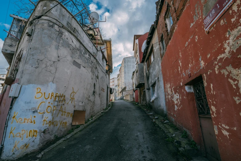 a narrow street in the middle of an abandoned village