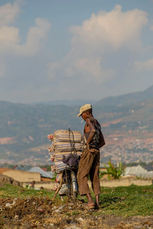 a man is standing on the back of his motorcycle with many bags on it