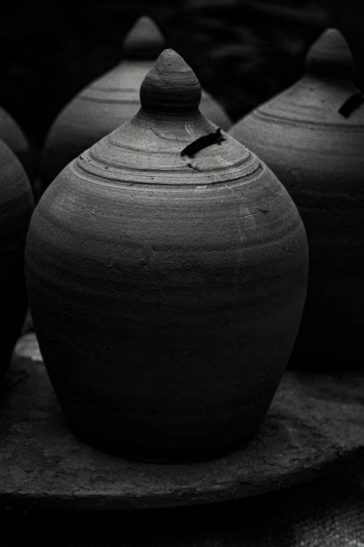 a group of clay containers lined up on a counter