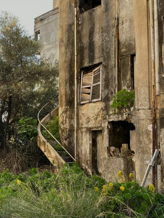 an old, run down stone building with window boxes on the outside