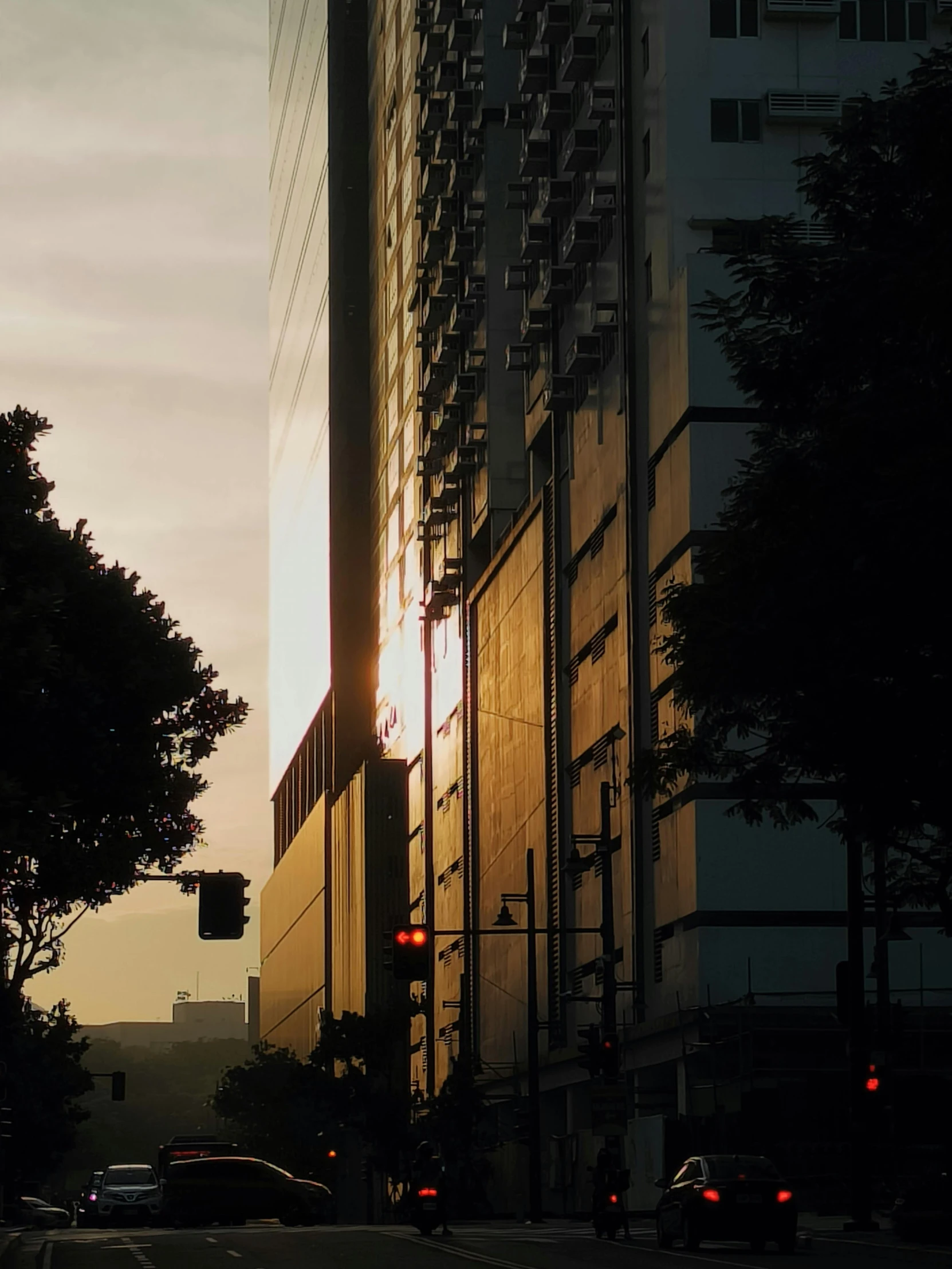 a traffic light on an intersection next to a tall building