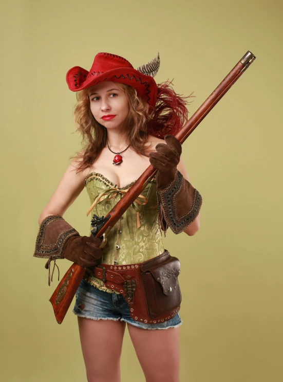 a beautiful woman dressed in a costume holding a rifle