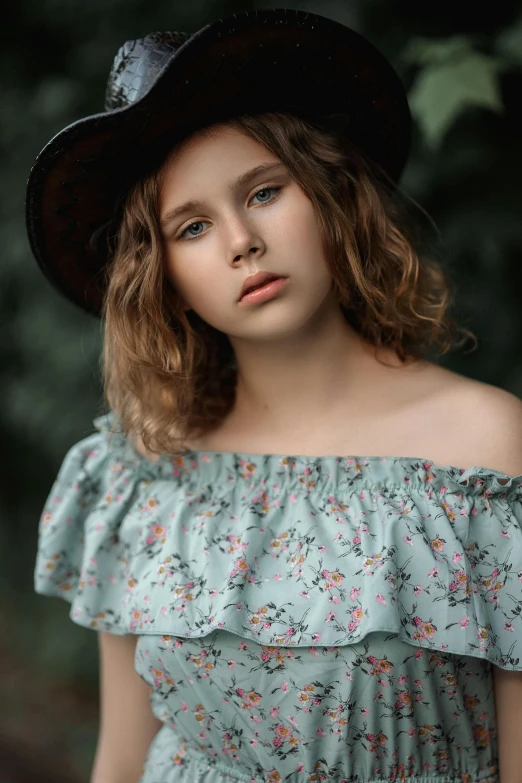 a beautiful young lady with a big hat on