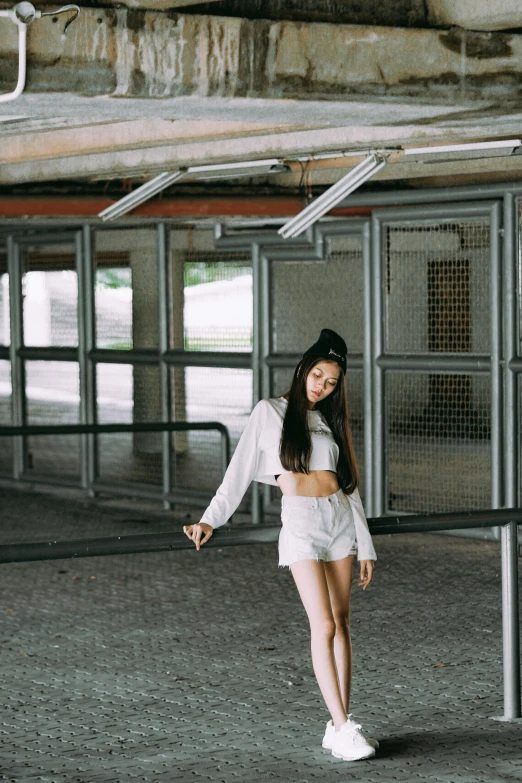 a young female in a short skirt and jacket posing