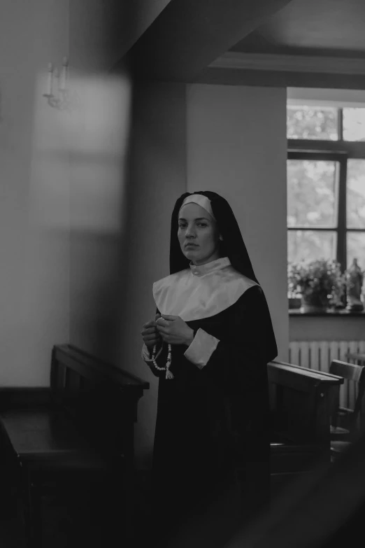 a nun is standing in the room