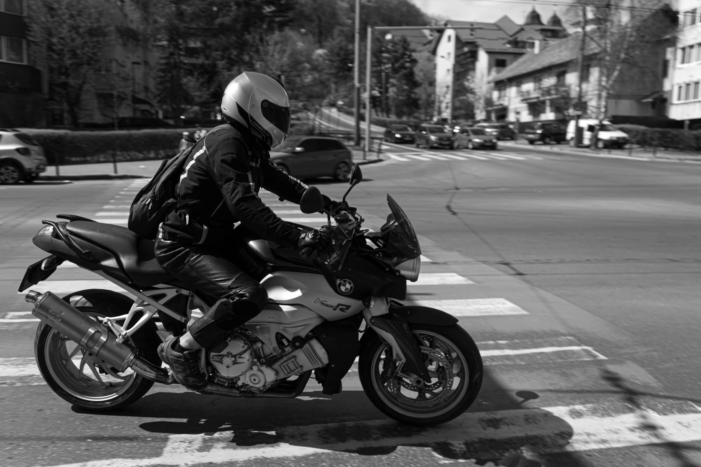 a man on a motorcycle crossing a street