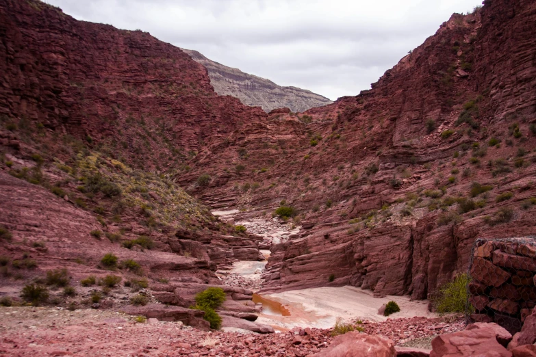 a dry creek running through a mountain landscape