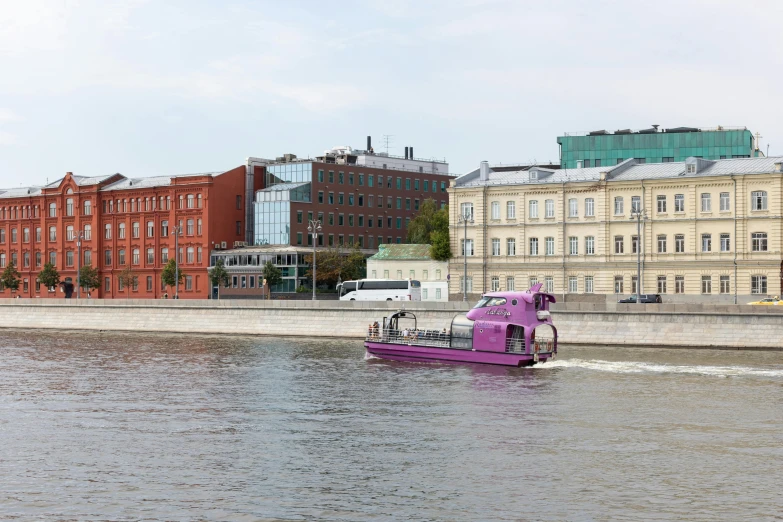 a boat traveling on water near city buildings