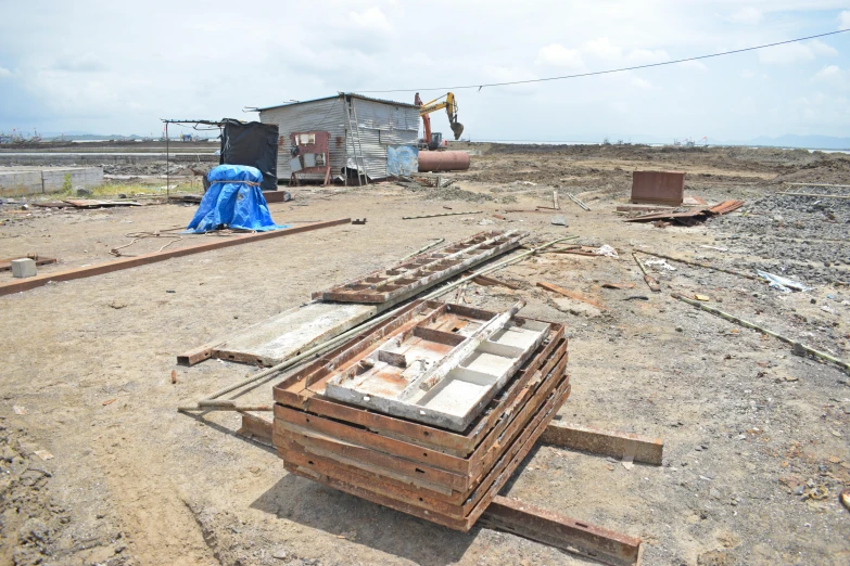 some rusty building materials and a blue tarp