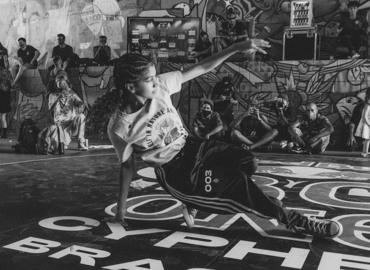 a black and white po of a skateboarder skating down a floor with other skateboards