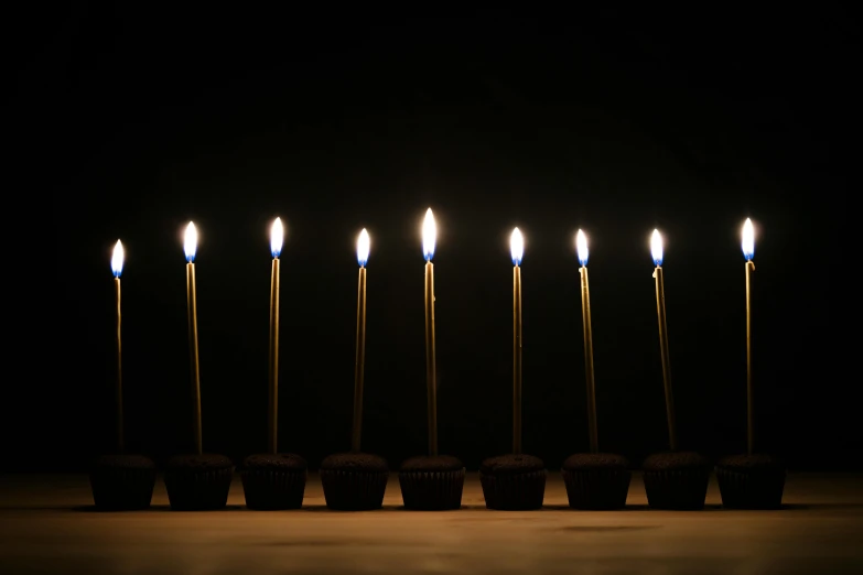 six rows of candles with black background
