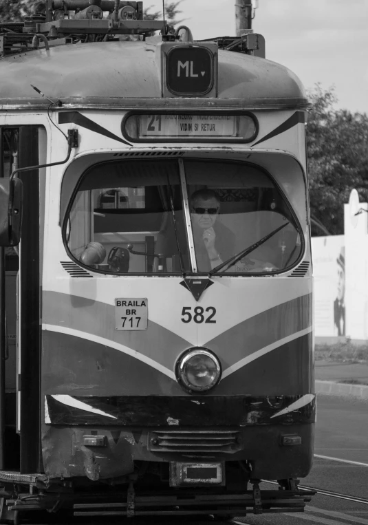 an old fashioned train car traveling down the street