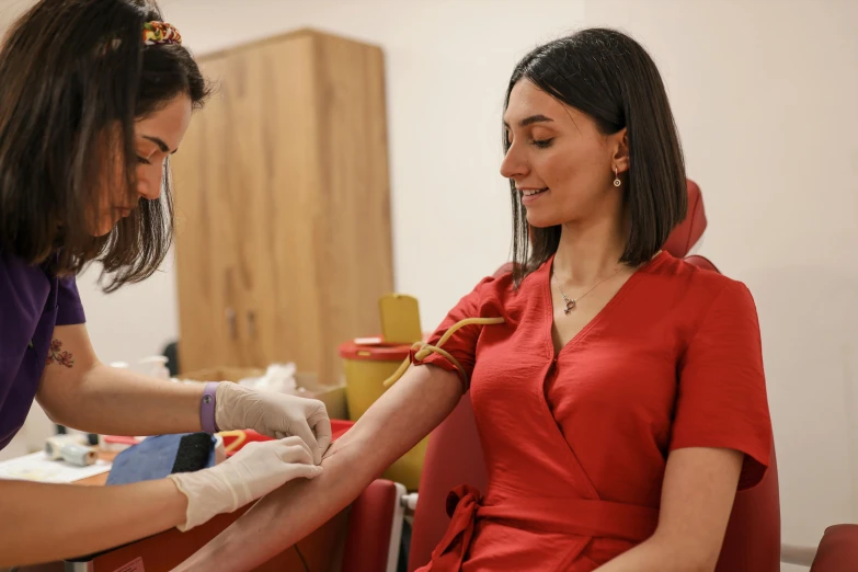 a woman wearing gloves is giving another woman soing