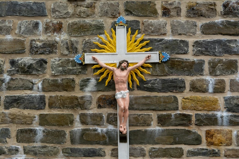 a man is crucififixion on the stone wall