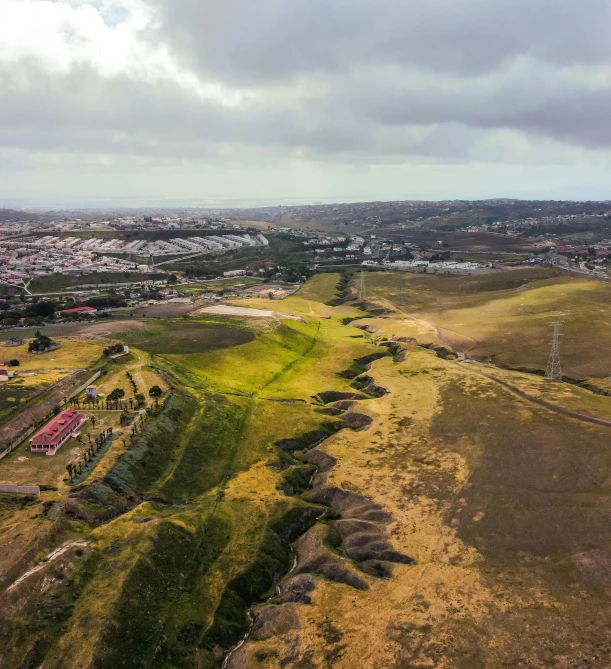 the view from the air of a dirt track and town