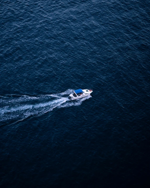 a speedboat is racing across an open sea