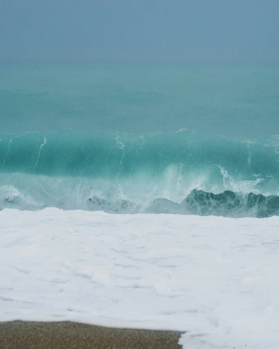 a man with a surfboard is standing in the snow