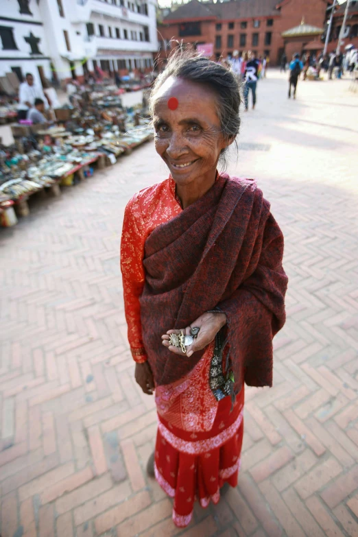 a women with a scarf standing on a street