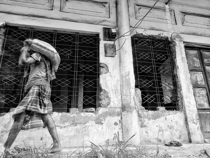 a woman walking down the street carrying a basket