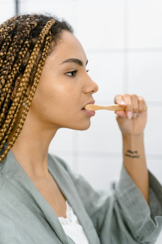 a woman brushing her teeth in the bathroom