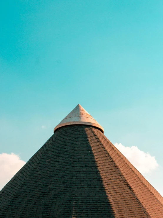 a triangular roof with a white tiled dome