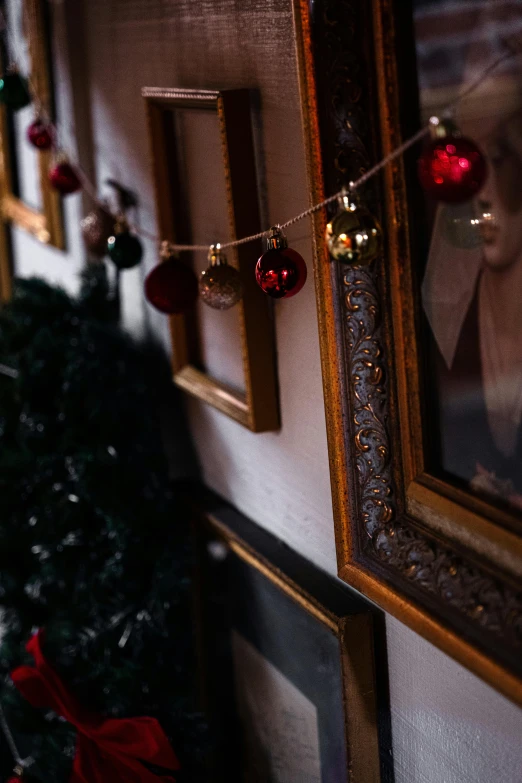 christmas decorations and a po are hanging on a wall