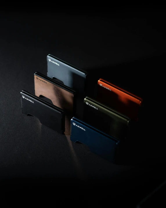 three different wallets with a dark background