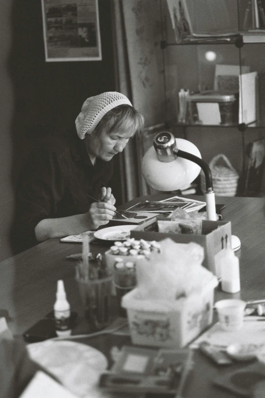 a black and white po of a child sitting at a table