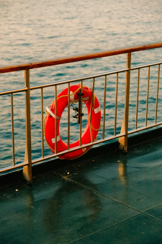 a red life preserver on a dock overlooking the water