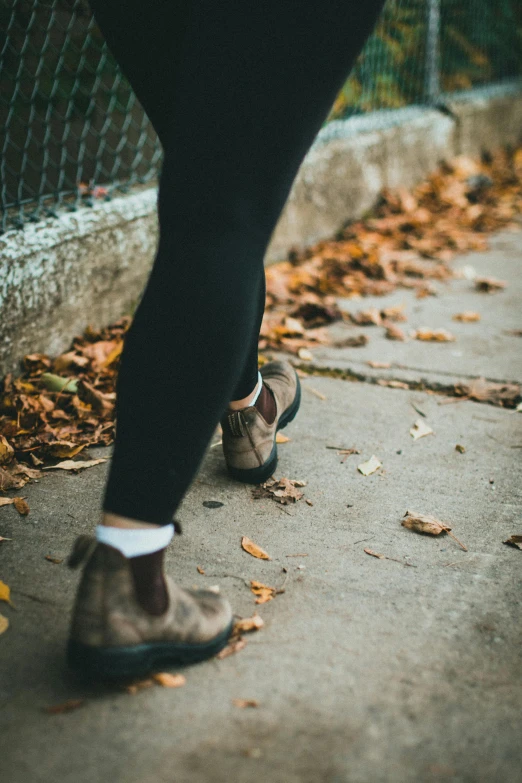 someone standing on the curb with some shoes