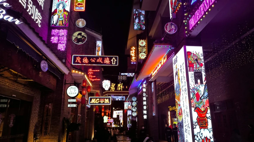 an alley with lots of brightly lit signs and people on it