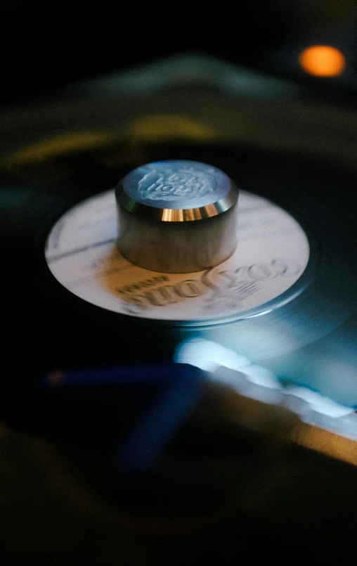 a close up of a silver disk with a ss cap on it