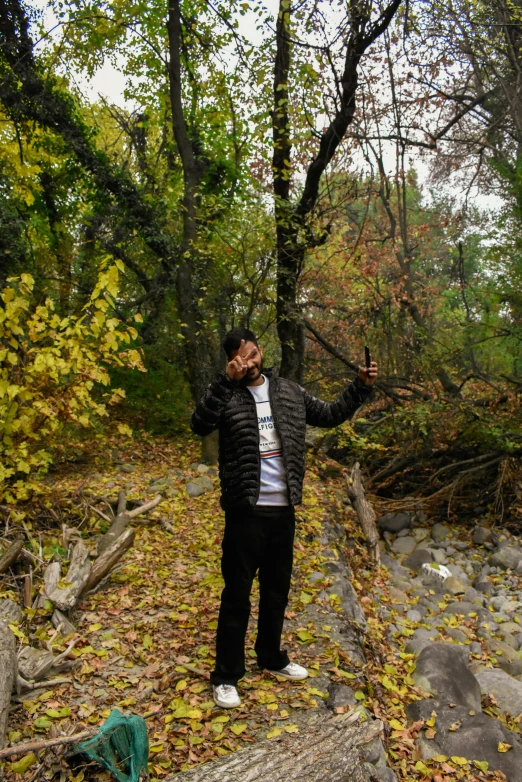 a man is standing near a fallen tree