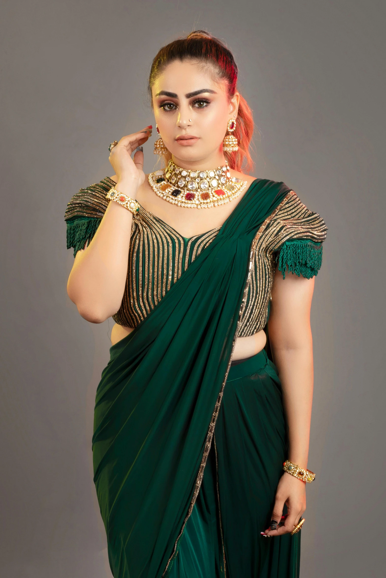 the woman in a green sari is posing