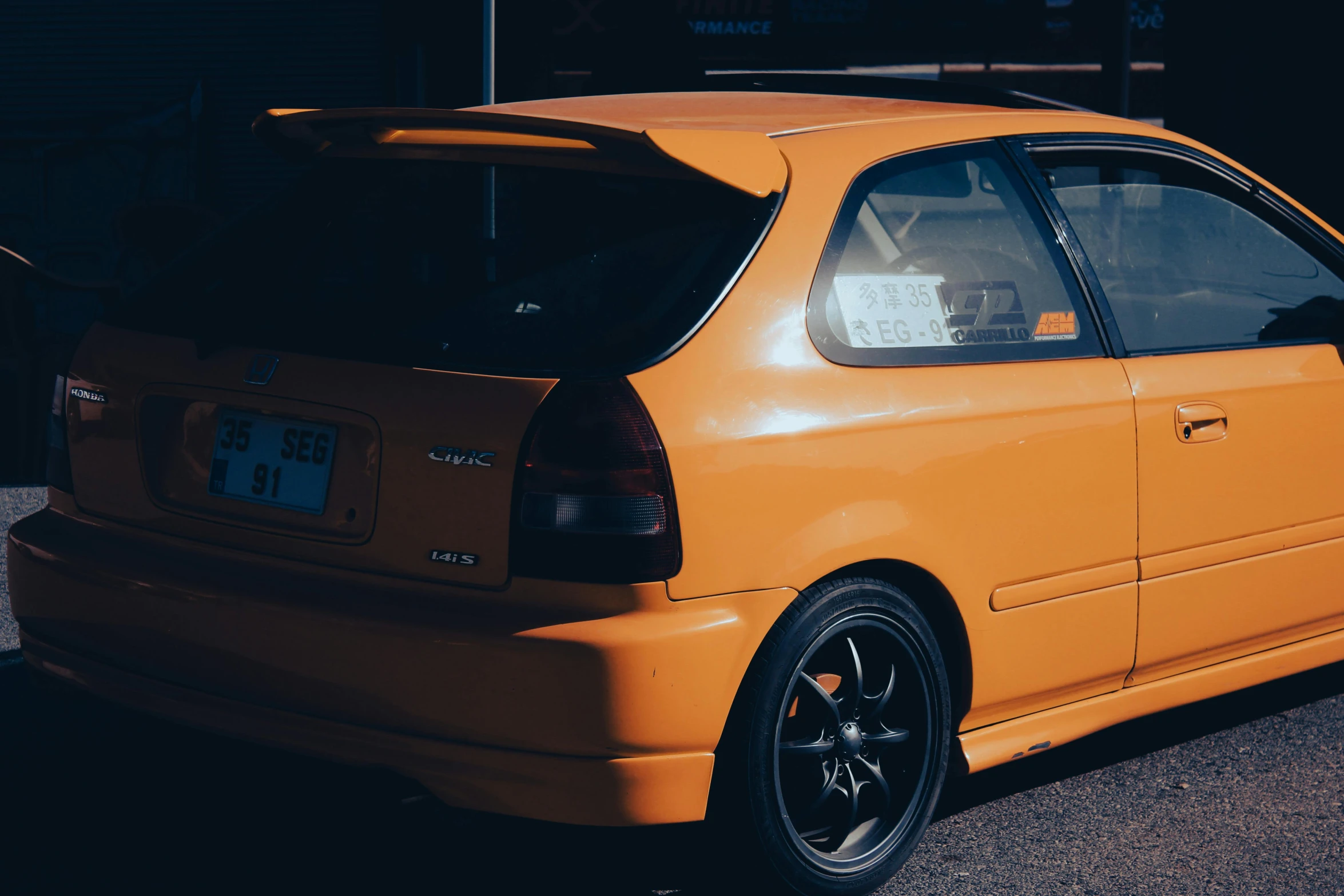 an orange car parked in the parking lot