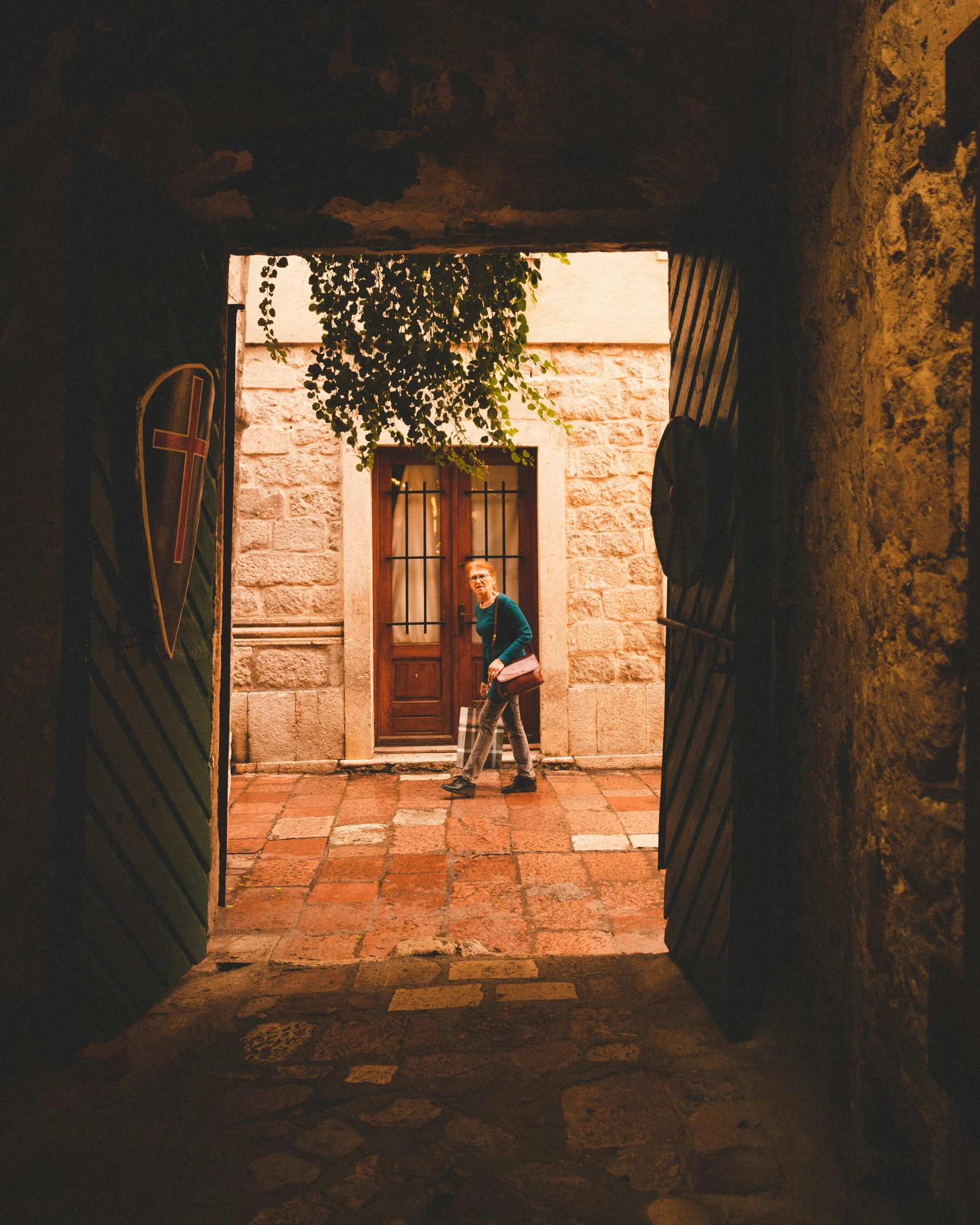 a boy sitting in a doorway with an umbrella