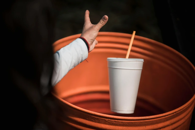 someone reaching for an empty cup in the shape of a circle