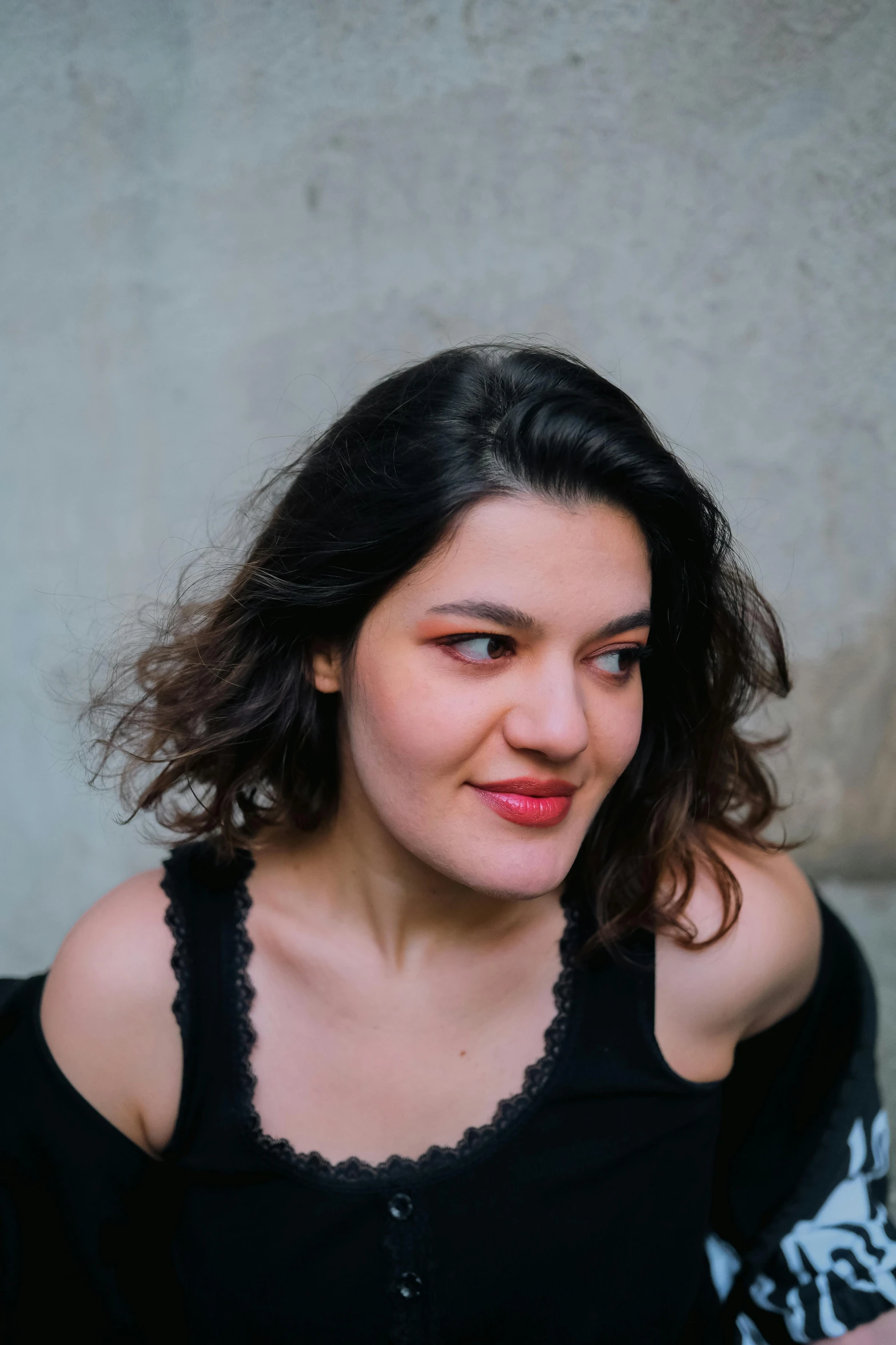 a close - up po of a young woman sitting and looking ahead