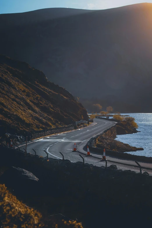 people standing along the side of a curved road