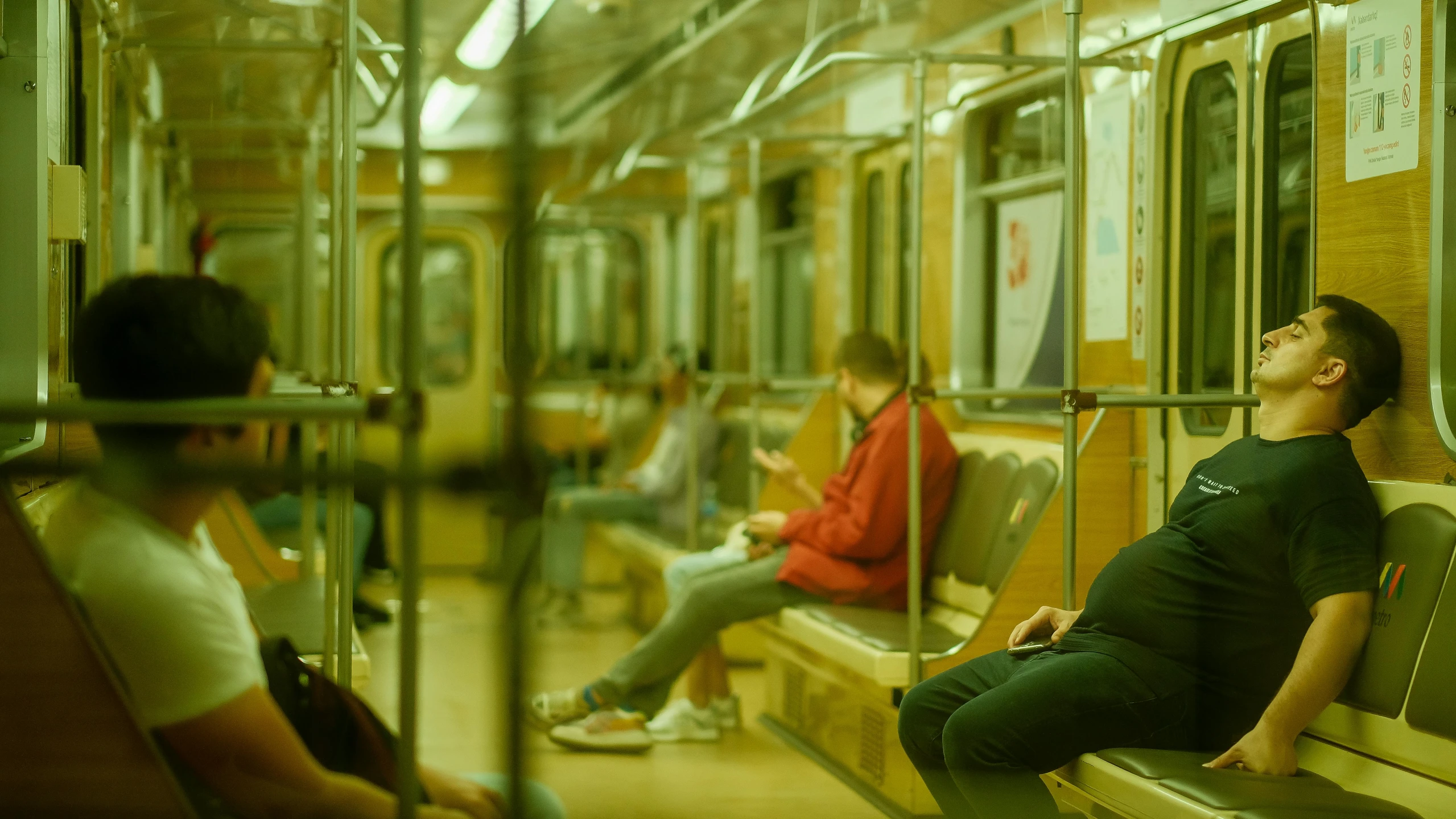 two people in a train while the others sit and watch