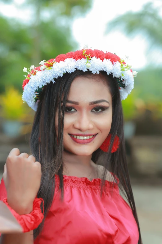 a woman wearing a red dress and a flowery headdress