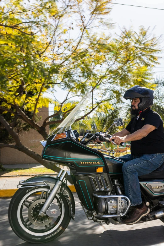 a man wearing a black shirt riding on a motorcycle