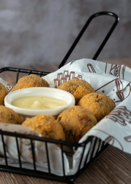 fried food item on black tray with dipping sauce