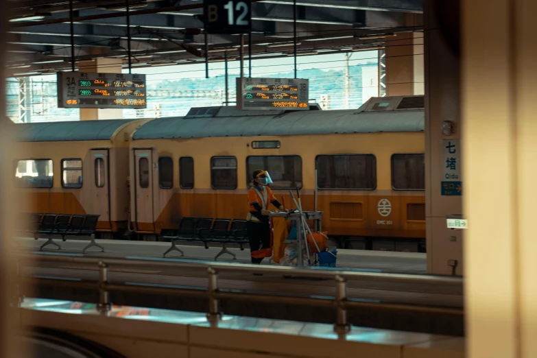 a woman that is walking past a train