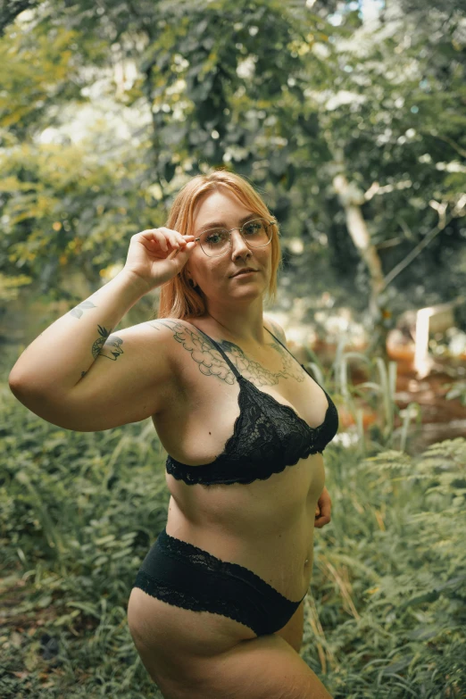 a beautiful woman in black lingerie in the woods