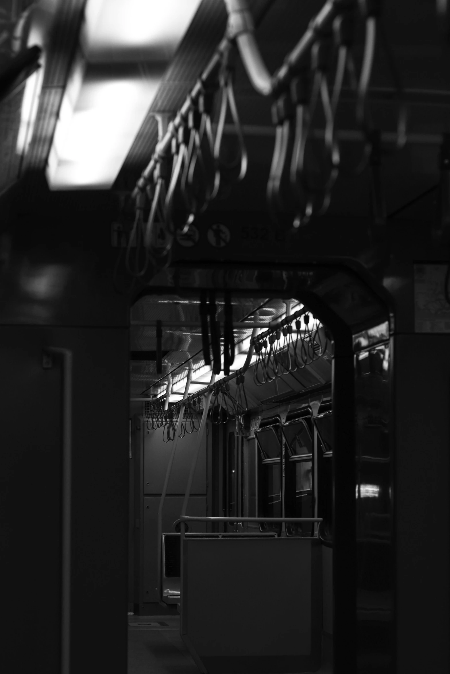 an empty train with some metal wires hanging down from it